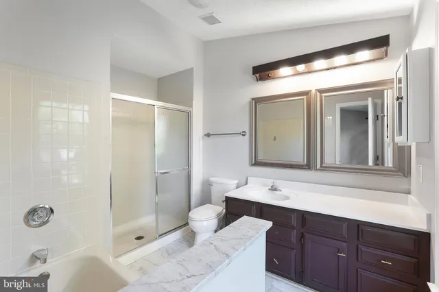 a bathroom with a double vanity sink mirror and shower