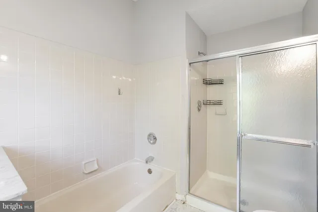 a bathroom with a bathtub and a shower