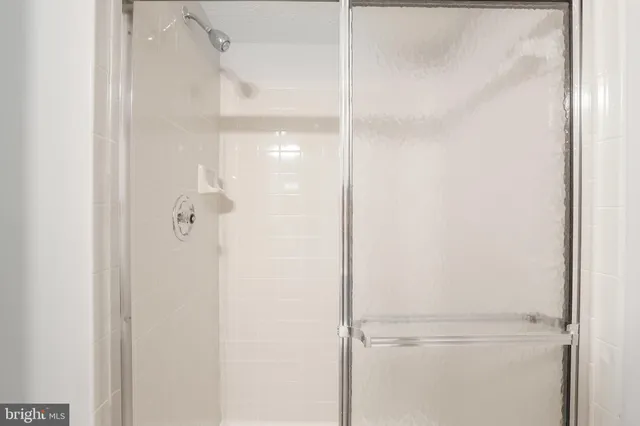 a bathroom with a glass shower door