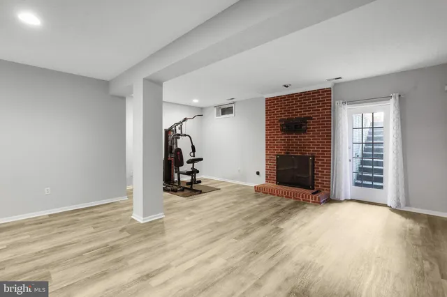 an empty room with furniture and a fireplace