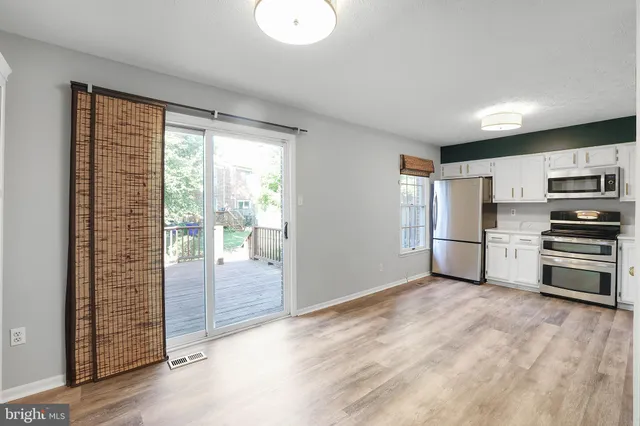 a kitchen with stainless steel appliances a refrigerator and a stove top oven