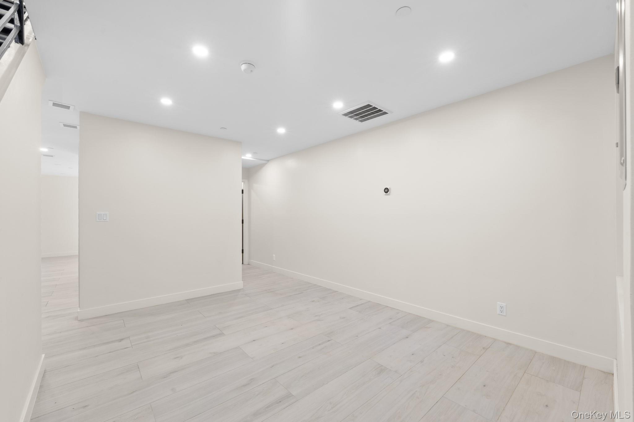 310 Fenimore Street, Unit 1 Brooklyn, NY 11225 - Photo 14 of 15 an empty room with wooden floor and windows