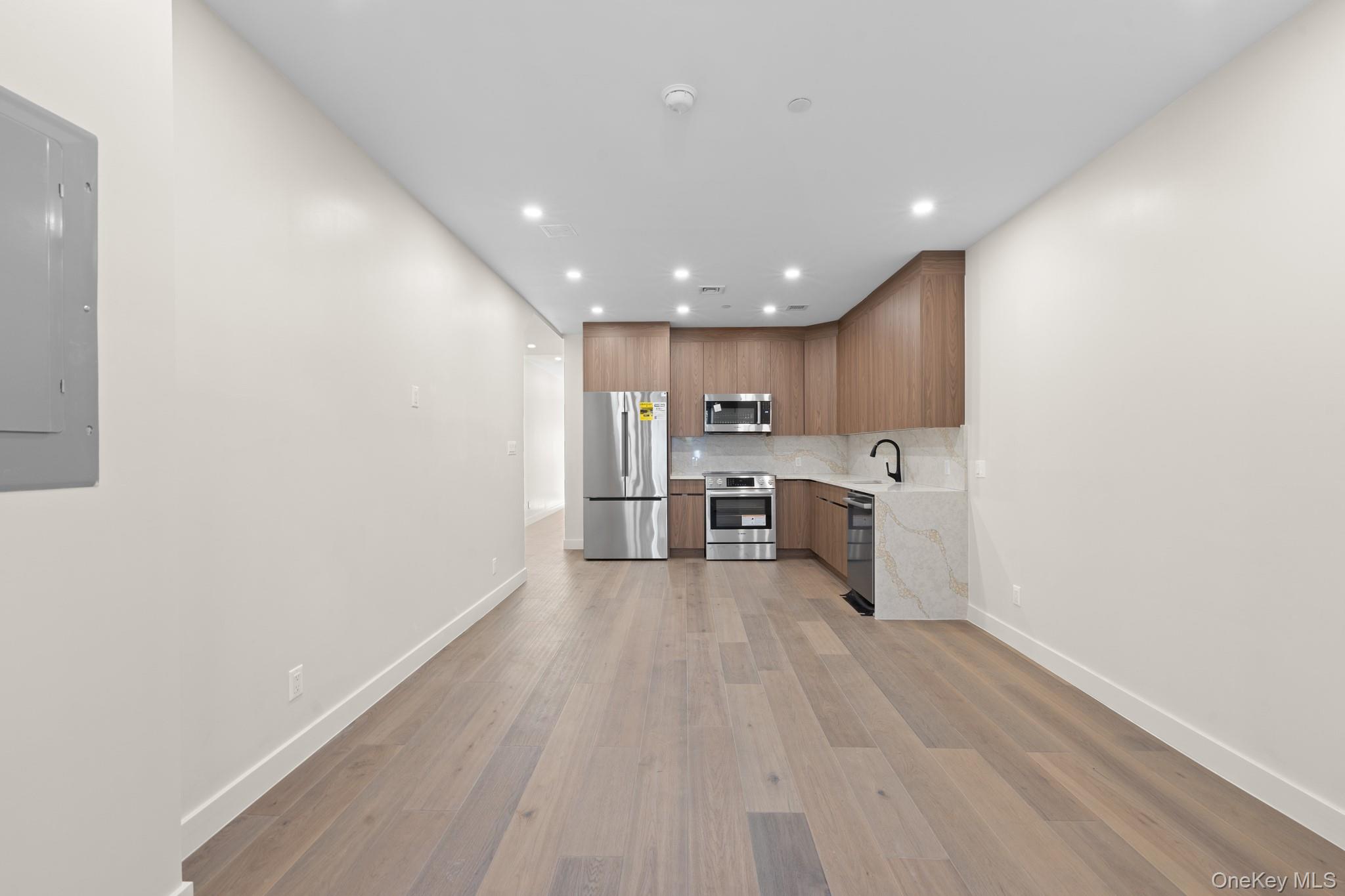 310 Fenimore Street, Unit 1 Brooklyn, NY 11225 - Photo 5 of 15 a view of a kitchen with a sink and dishwasher a refrigerator with wooden floor