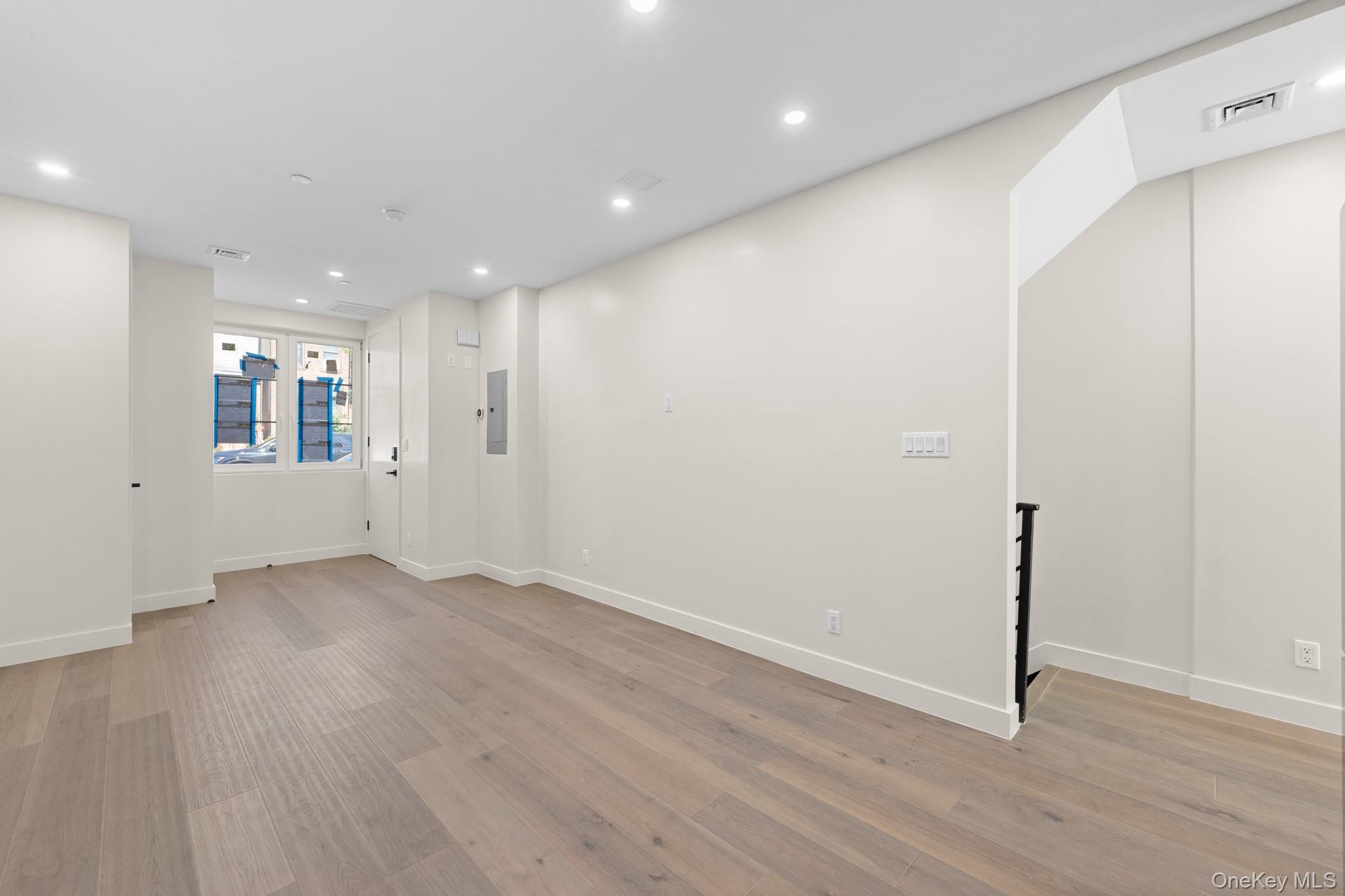 310 Fenimore Street, Unit 1 Brooklyn, NY 11225 - Photo 7 of 15 an empty room with wooden floor and windows