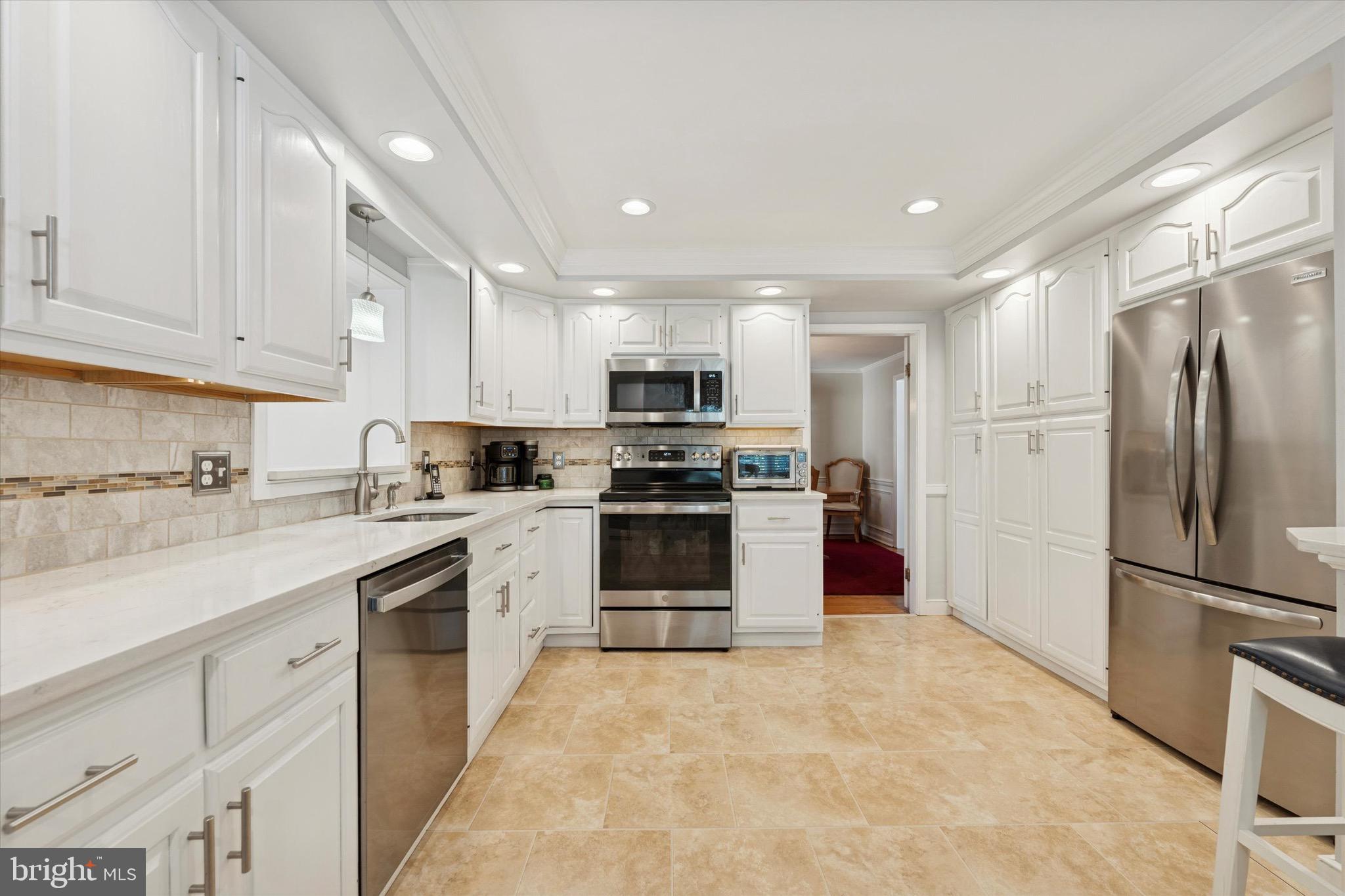 147 Snyder Lane Springfield, PA 19064 - Photo 7 of 42 Refinished cabinets and quartz countertops.