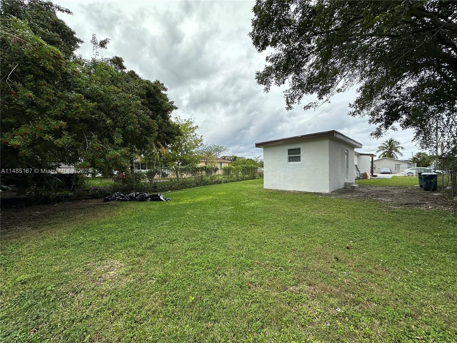 11470 Southwest 215th Street Miami, FL 33189 - Photo 16 of 18 a house view with a garden space