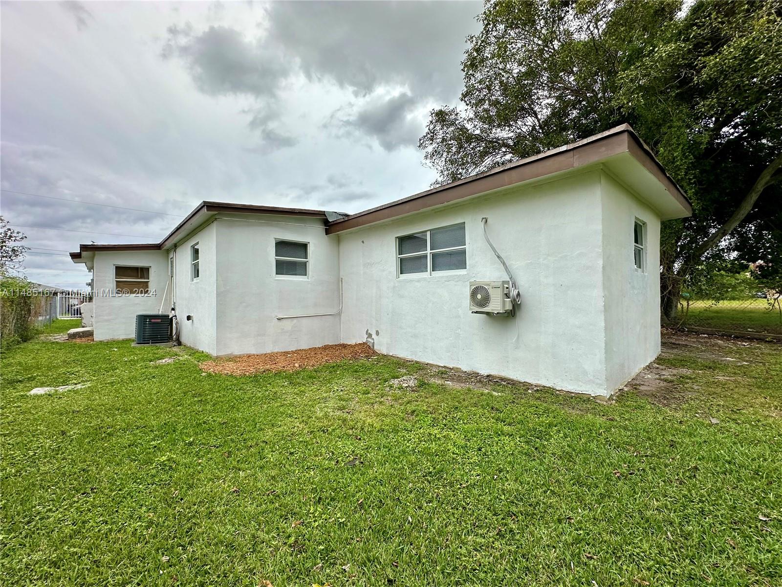 11470 Southwest 215th Street Miami, FL 33189 - Photo 18 of 18 a house view with a garden space