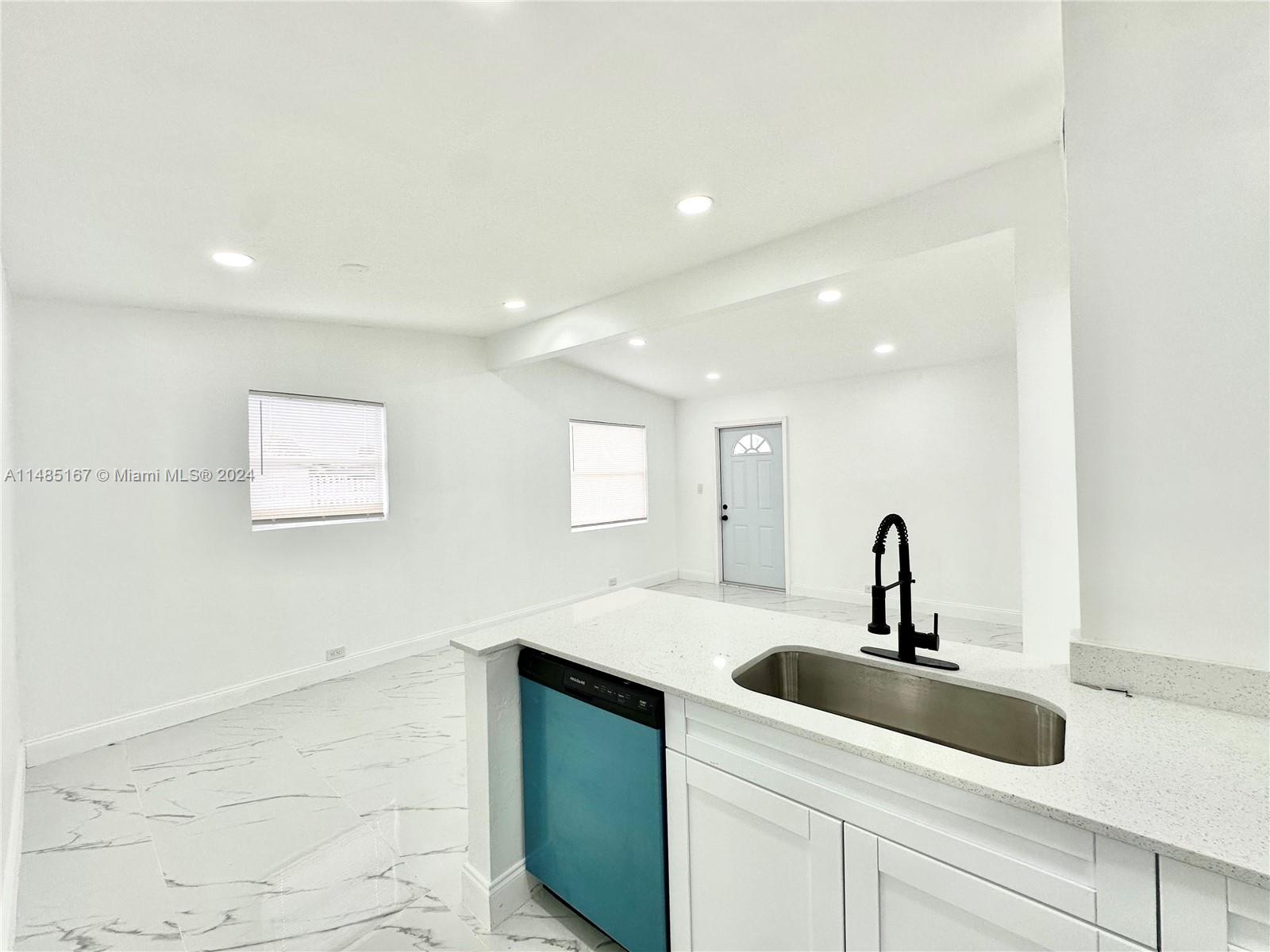 11470 Southwest 215th Street Miami, FL 33189 - Photo 8 of 18 a kitchen with a sink and a mirror