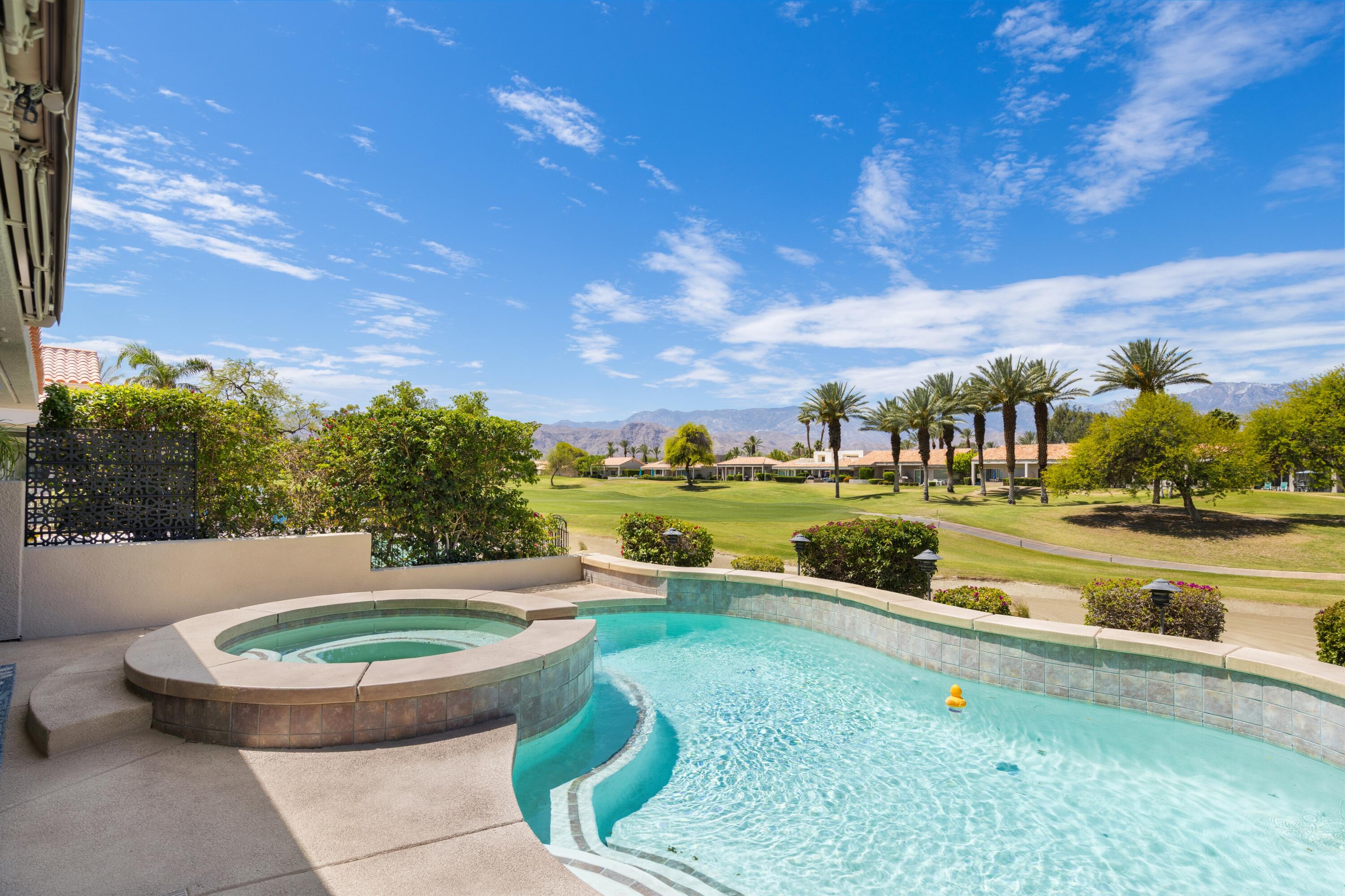 39 Augusta Drive Rancho Mirage, CA 92270 - Photo 44 of 53 a view of a swimming pool with a lounge chair and a big yard