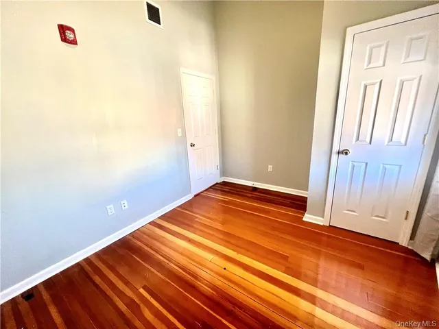 a view of a room with wooden floor and cabinet