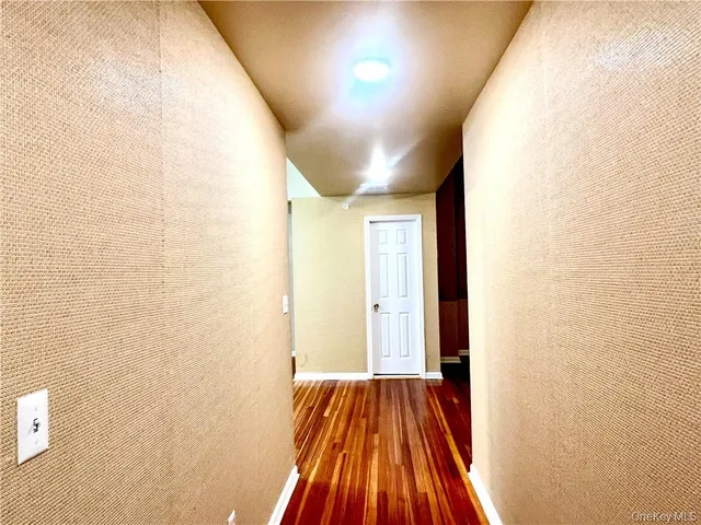 a view of hallway with wooden floor