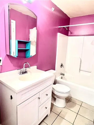 a bathroom with a sink toilet vanity and tub