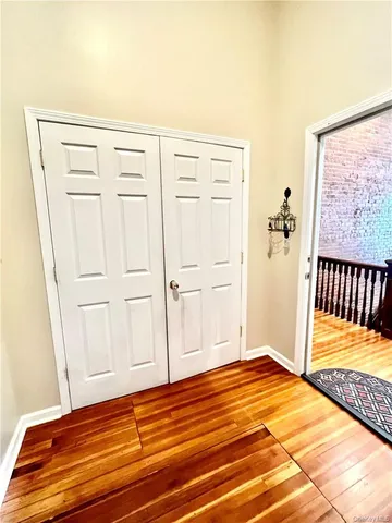 a view of a livingroom with wooden floor and white walls