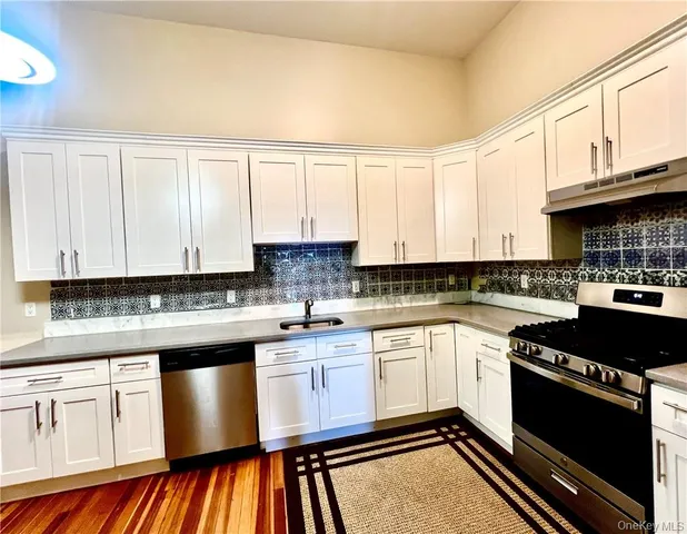 a kitchen with a cabinets appliances and a sink