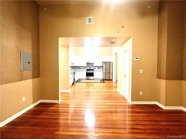 a view of a living room with furniture and wooden floor