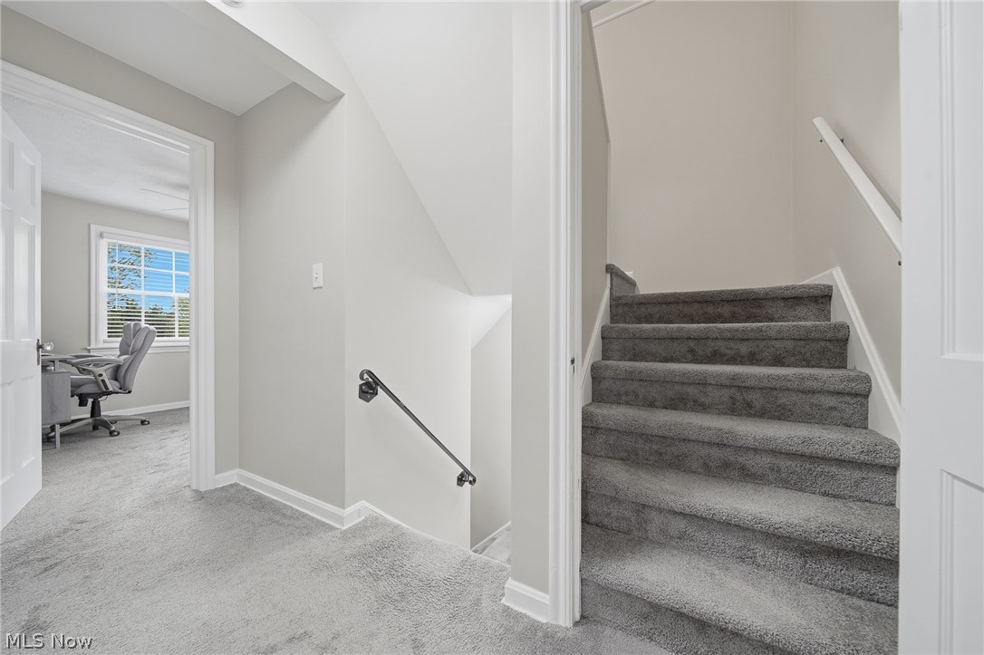 2231 Brockway Road University Heights, OH 44118 - Photo 25 of 46 Grey carpeted staircase featuring a black wrought iron handrail