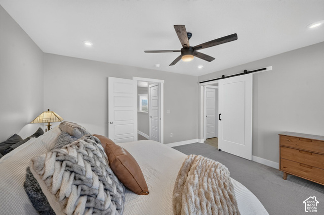 1081 Bowery Way Mapleton, UT 84664 - Photo 23 of 41 Recessed lighting, ceiling fan with integrated light, gray wall finishes, gray carpeting, and a white barn door on a black track