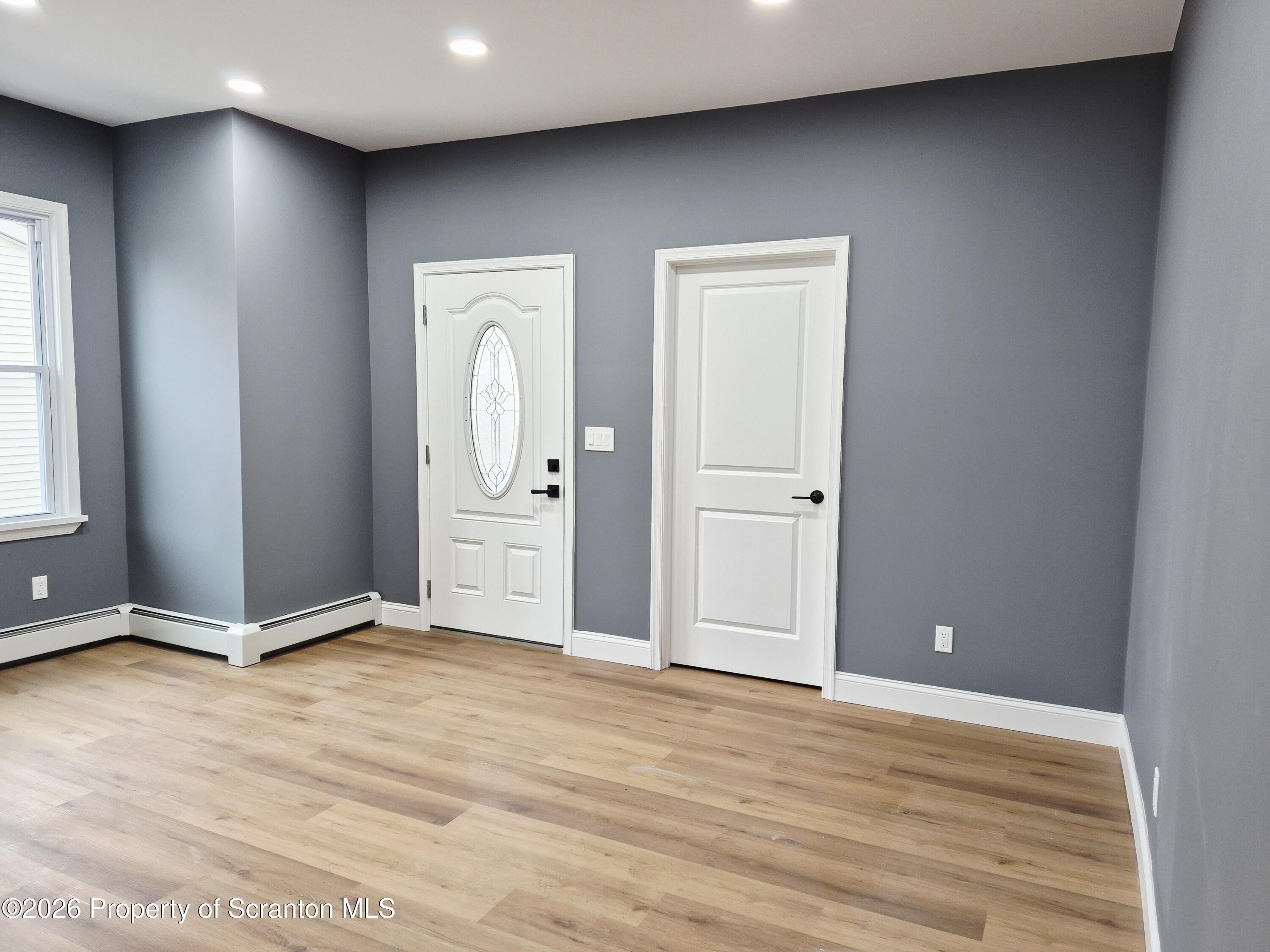 1132 Lloyd Street Scranton, PA 18508 - Photo 11 of 37 a view of an empty room with closet and wooden floor