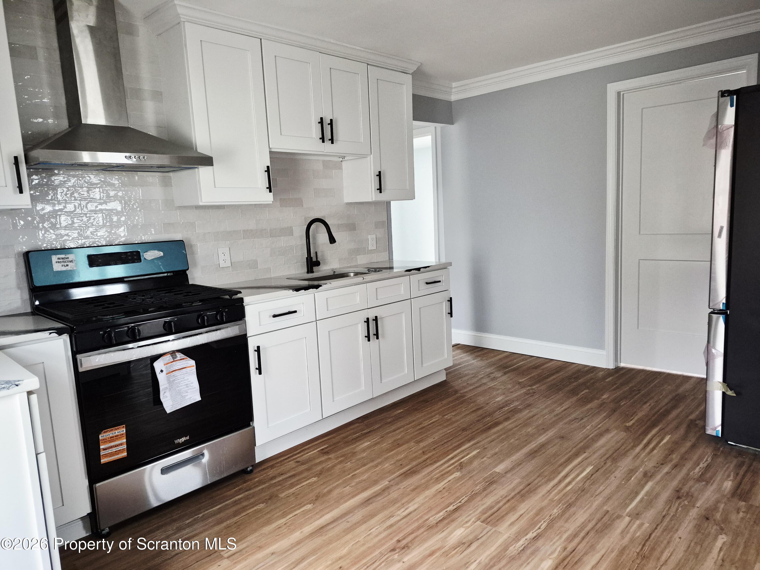 1132 Lloyd Street Scranton, PA 18508 - Photo 19 of 37 a kitchen with stainless steel appliances granite countertop a stove a sink and a refrigerator