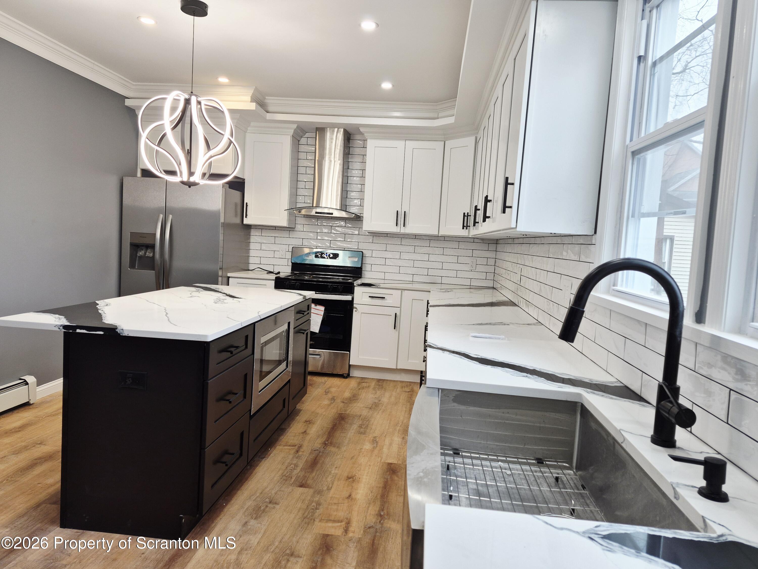 1132 Lloyd Street Scranton, PA 18508 - Photo 5 of 37 a kitchen with a stove sink and a refrigerator