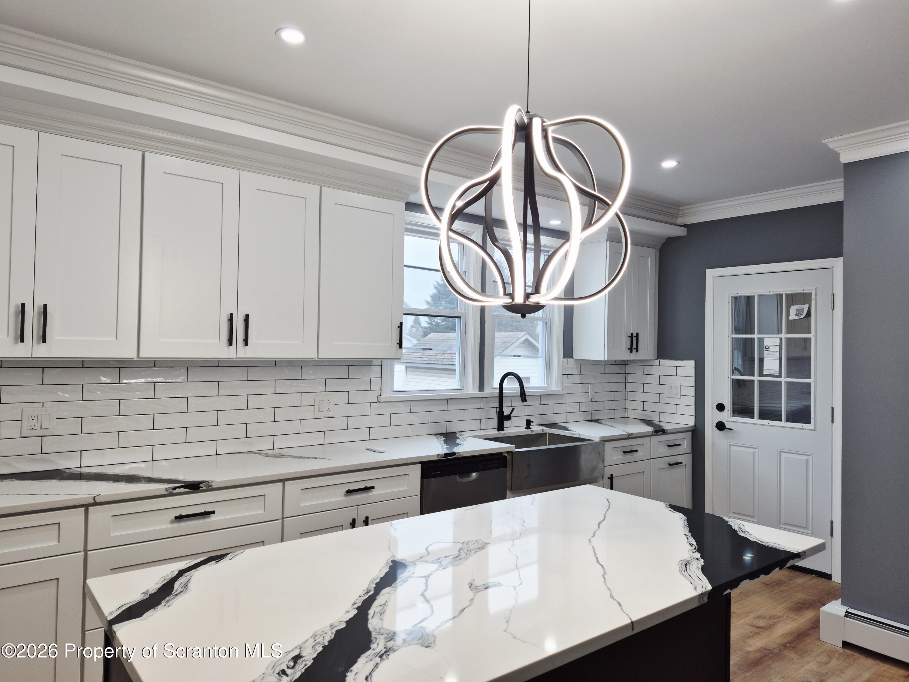 1132 Lloyd Street Scranton, PA 18508 - Photo 7 of 37 a kitchen with stainless steel appliances a sink a stove and cabinets
