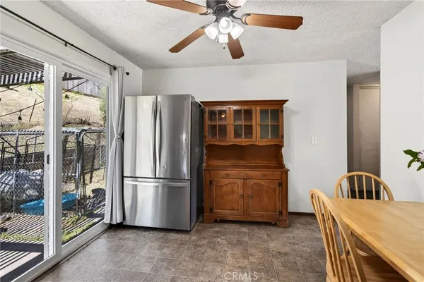a kitchen with refrigerator cabinets and ceiling fan