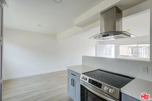 a stove top oven sitting inside of a kitchen