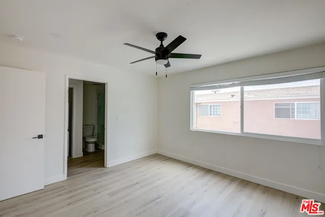 a view of a livingroom with a ceiling fan and window