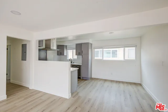a room with a wooden floor and white walls