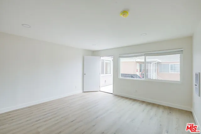 a view of room with window and hardwood floor
