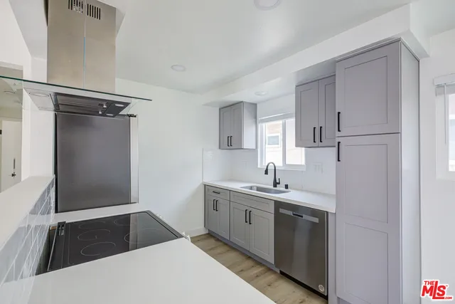 a kitchen with a sink and refrigerator