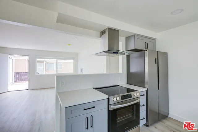 a kitchen with a stove and a refrigerator