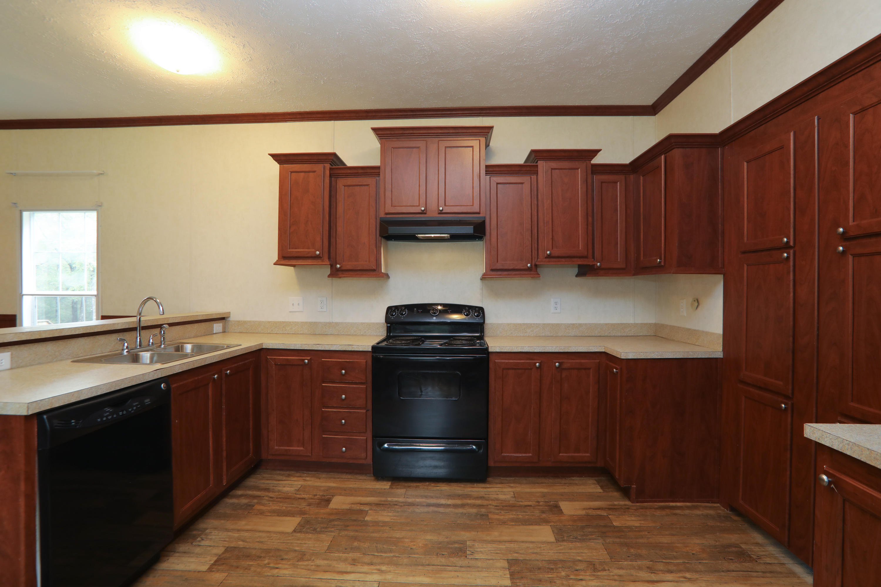 180 Spring Hill Road DeFuniak Springs, FL 32433 - Photo 3 of 17 a kitchen with stainless steel appliances granite countertop wooden cabinets a stove top oven a sink and dishwasher