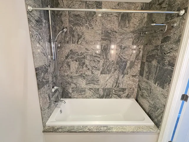 a view of an empty room with a chandelier fan