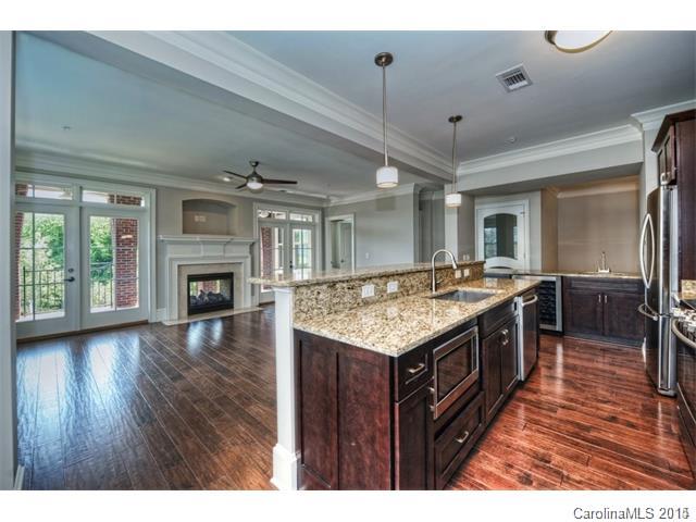 2100 Queens Road West, Unit 2128 Charlotte, NC 28207 - Photo 3 of 8 a kitchen with a stove and a wooden floor