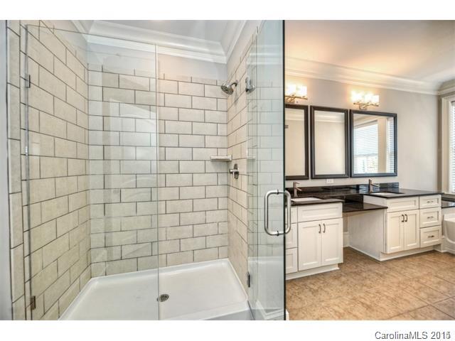 2100 Queens Road West, Unit 2128 Charlotte, NC 28207 - Photo 4 of 8 a bathroom with a sink a granite counter top and a shower