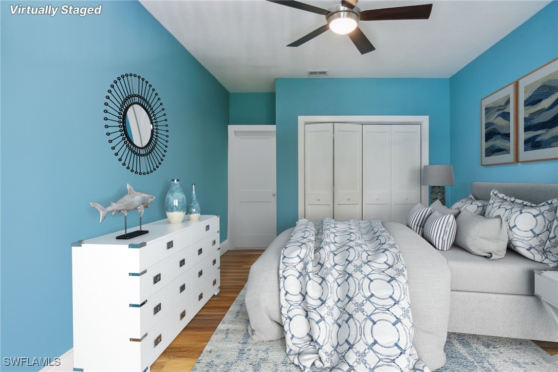 8335 Main Street Bokeelia, FL 33922 - Photo 39 of 47 a bedroom with bed and a chandelier