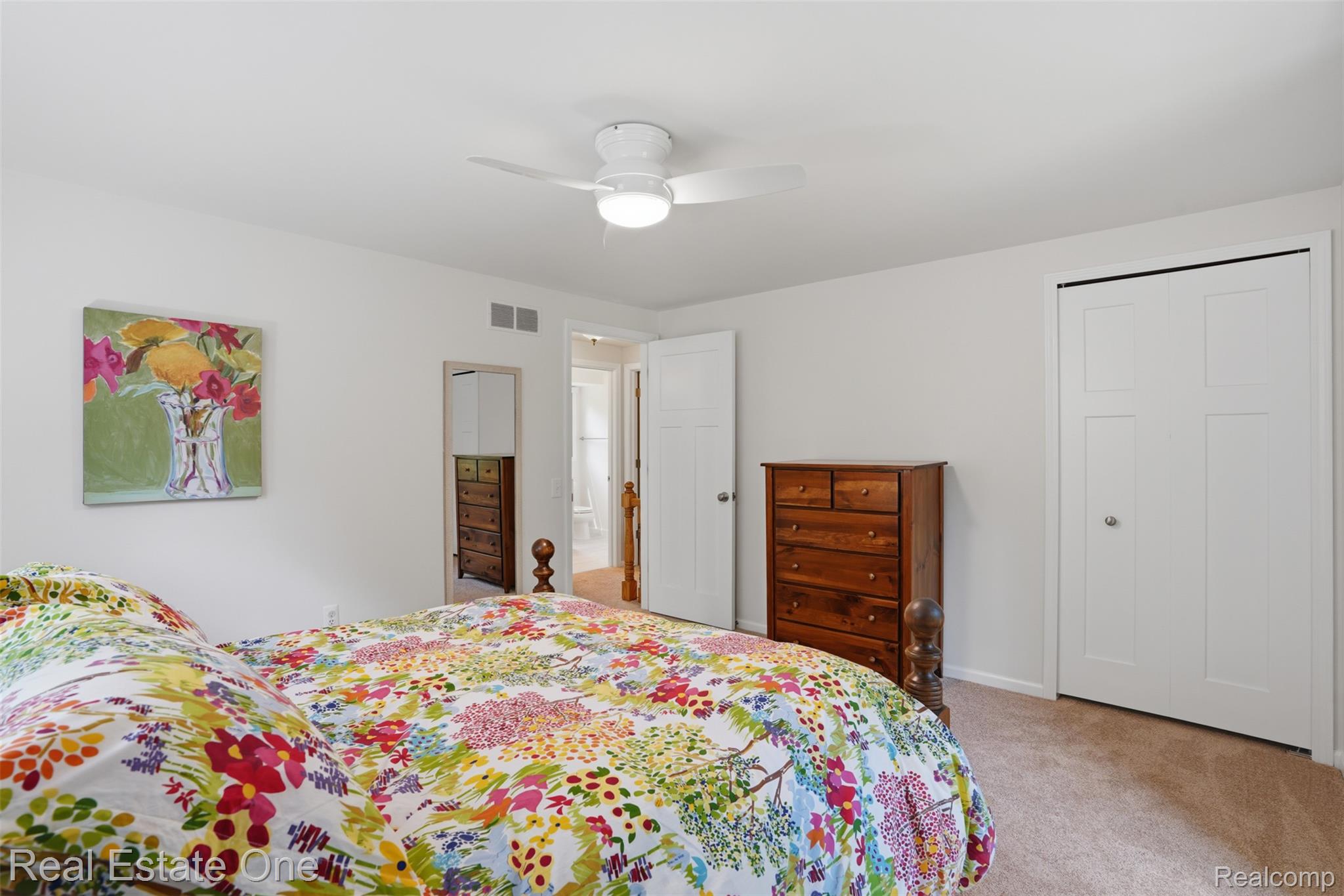 1765 Rowe Road Milford, MI 48380 - Photo 33 of 61 Bedroom featuring neutral carpeting, white walls, and a ceiling fan with integrated lighting