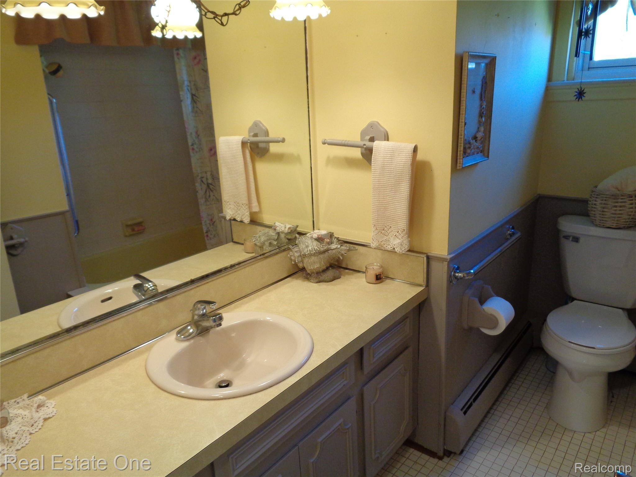 5960 Mills Road Deckerville, MI 48427 - Photo 45 of 79 Full bathroom with ceramic flooring and new toilet, updated faucet.