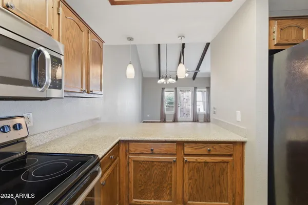 a kitchen with stainless steel appliances granite countertop a stove and a microwave