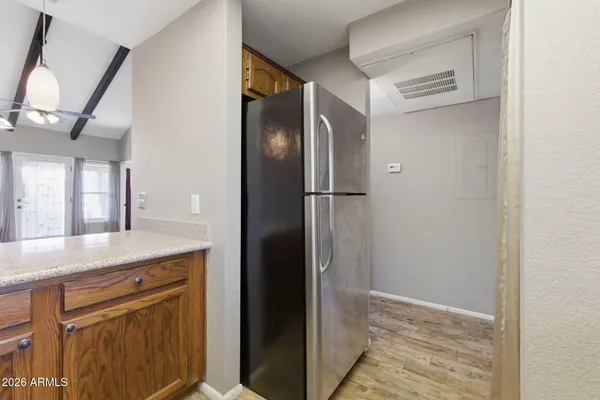a view of a refrigerator in kitchen and wooden floor