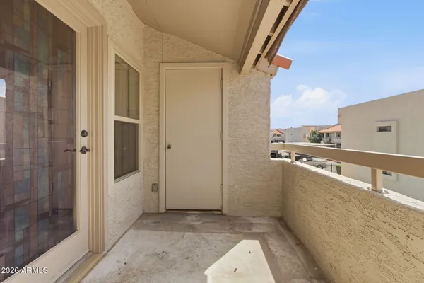 a view of a balcony with furniture