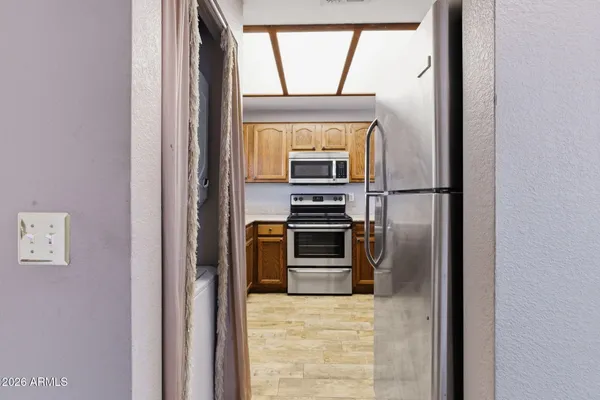 a kitchen with a refrigerator and a stove