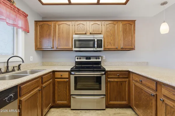 a kitchen with sink a microwave and stove