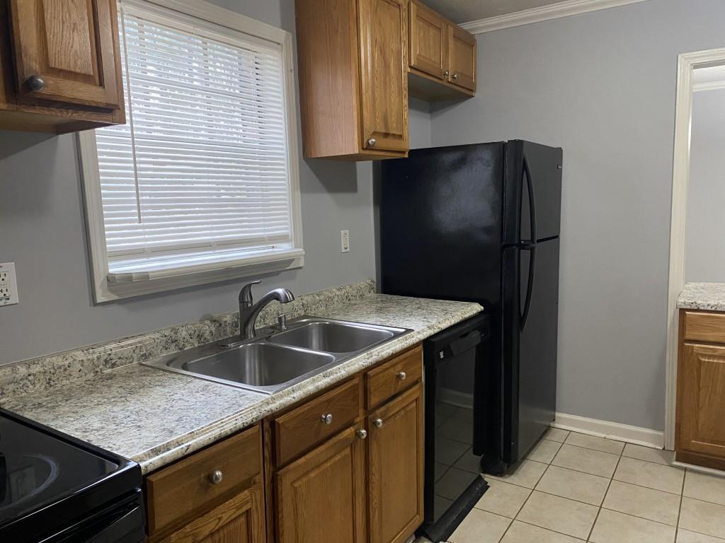 2340 Big Pine Court Conley, GA 30288 - Photo 19 of 25 a kitchen with a sink and a refrigerator