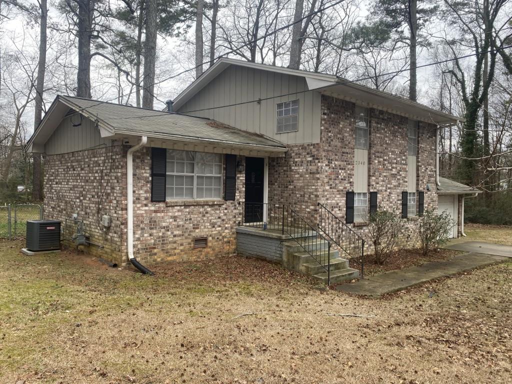 2340 Big Pine Court Conley, GA 30288 - Photo 2 of 25 a front view of a house with garden