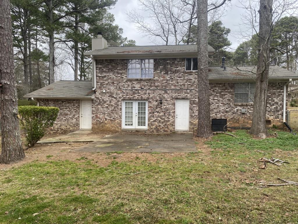 2340 Big Pine Court Conley, GA 30288 - Photo 3 of 25 a front view of a house with a garden
