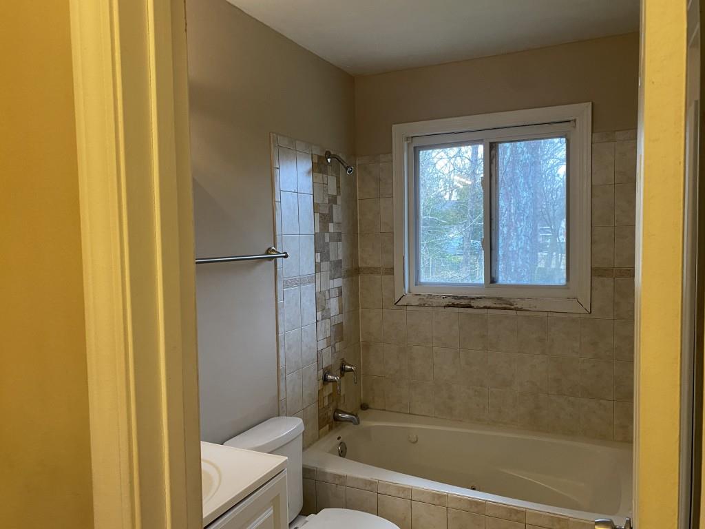 2340 Big Pine Court Conley, GA 30288 - Photo 10 of 25 a bathroom with a bathtub next to a window