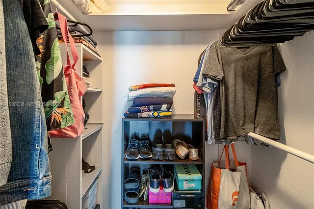 a view of a patio with couches chairs potted plants and wooden floor