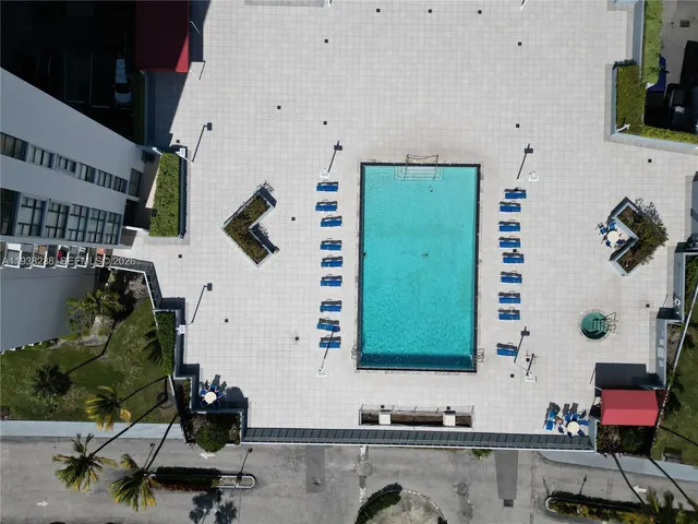 a room with pool table and wooden floor